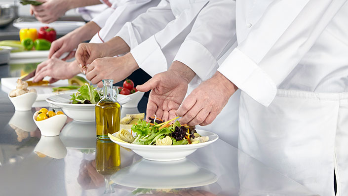 food being plated in a kitchen