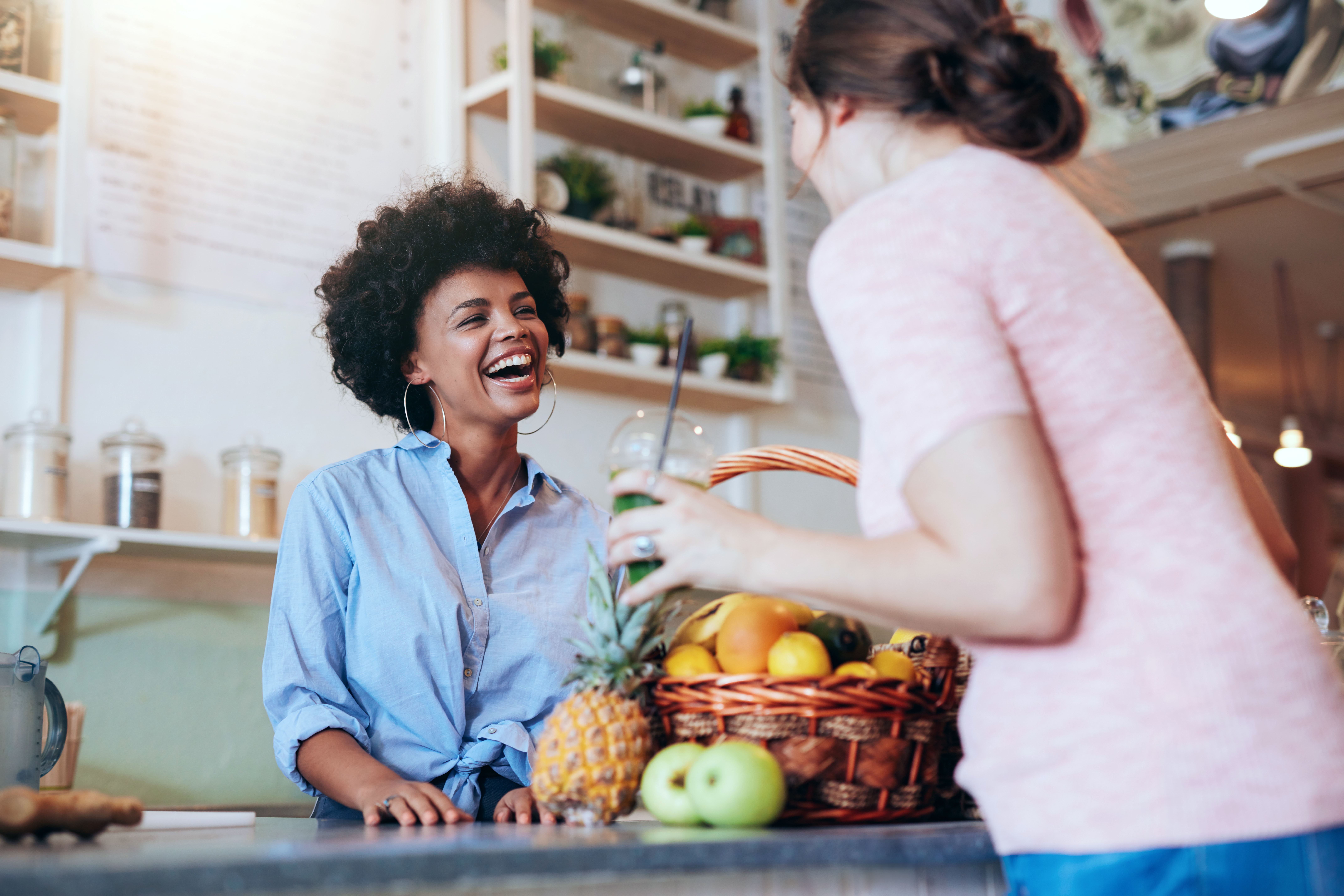 young woman of colour smiling in a commercial kitchen