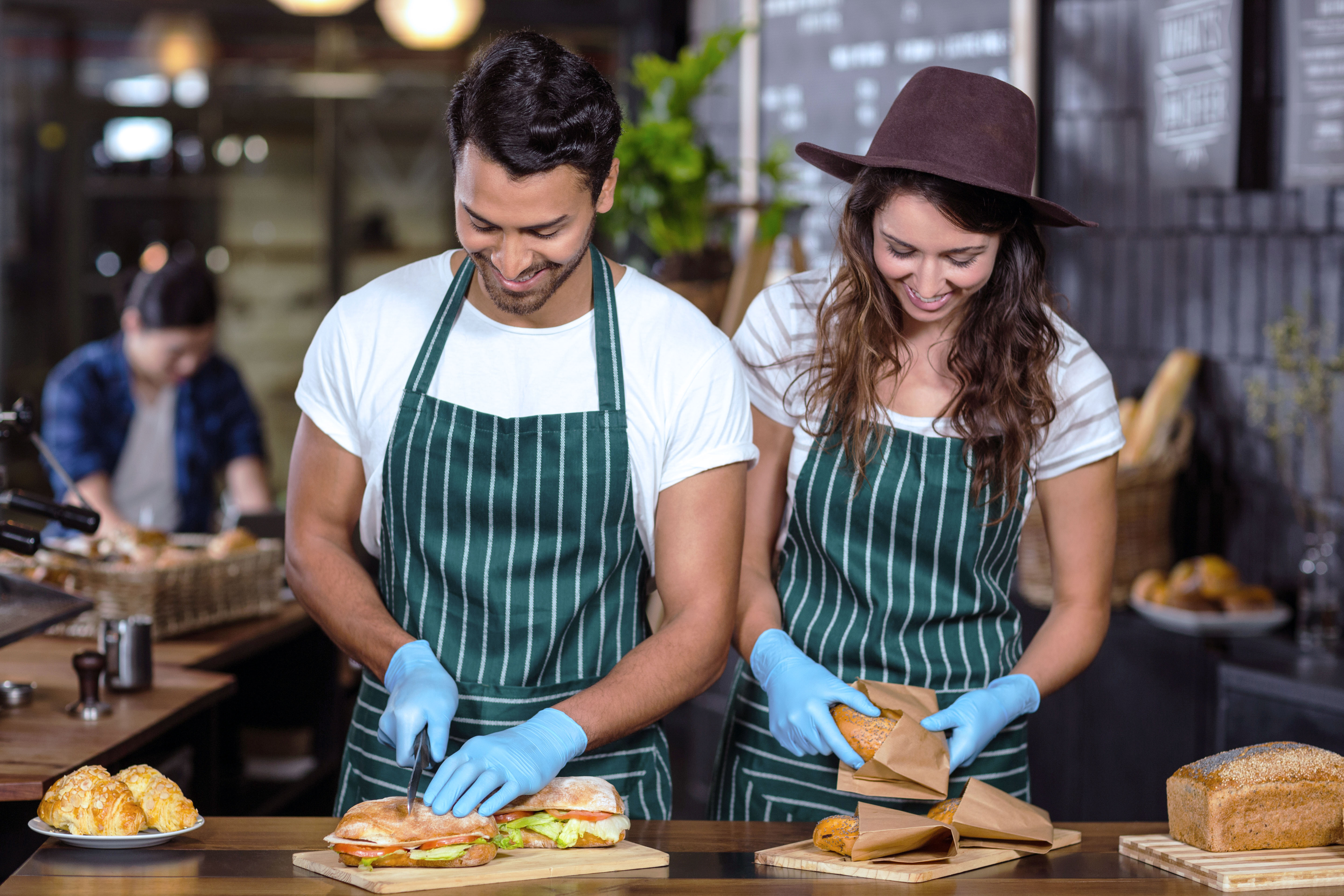 young food workers preparing food in a cafe