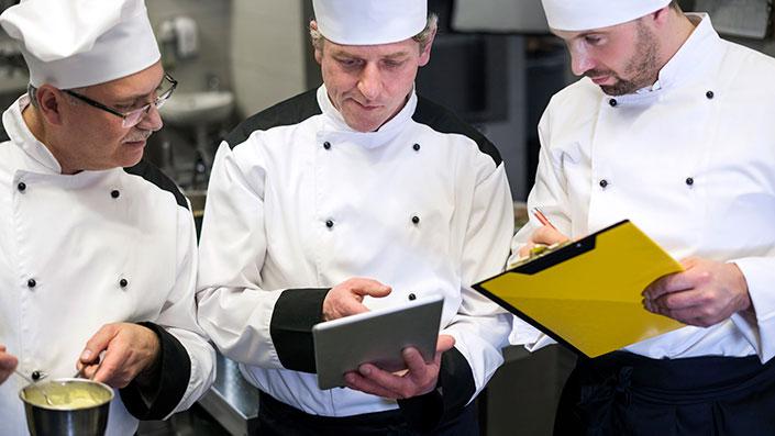 restaurant chefs reviewing inventory records